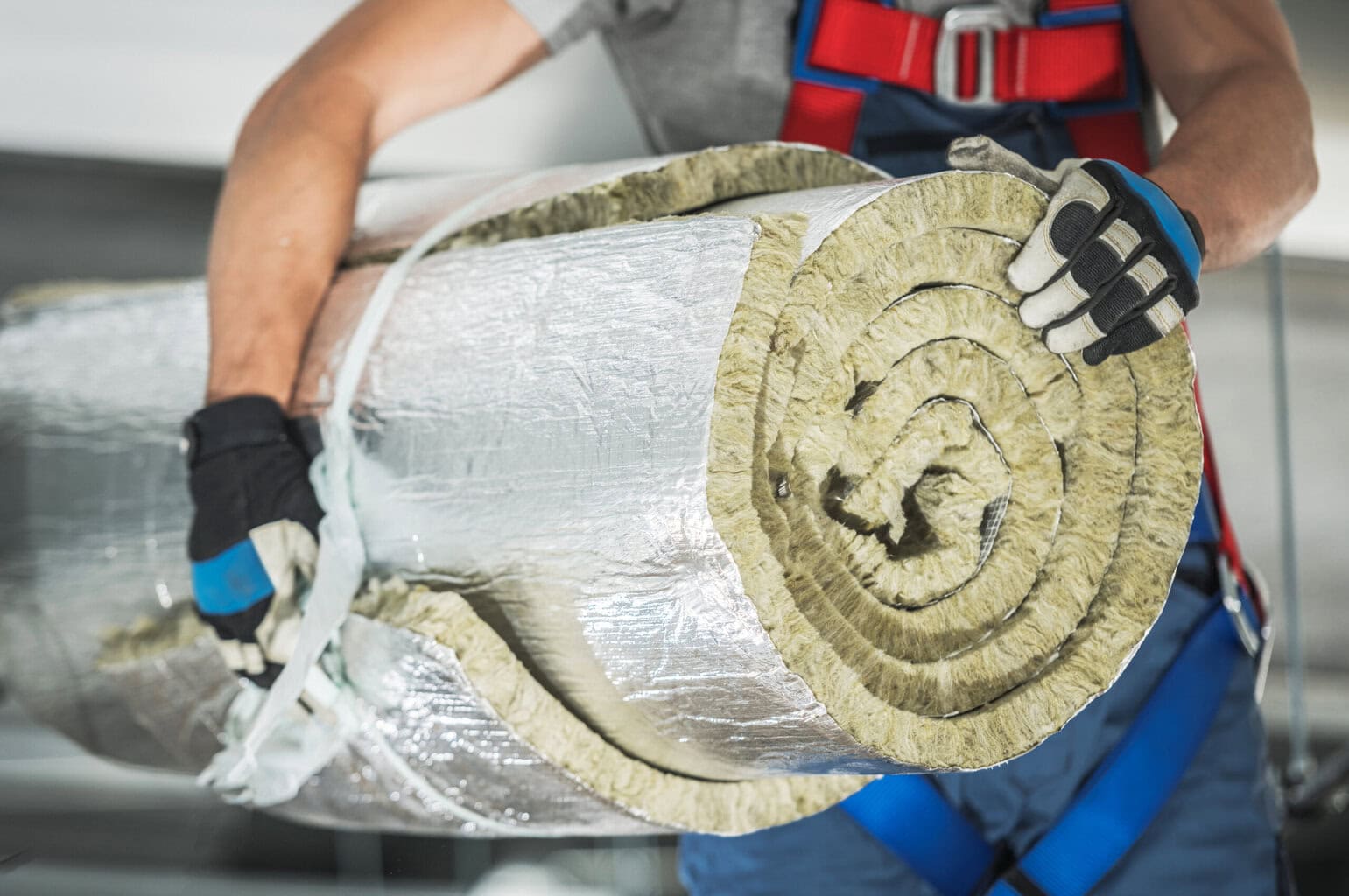 Installatore isolante termico Installatore con isolamento termico in fibra di vetro, lavoro di isolamento edilizio.